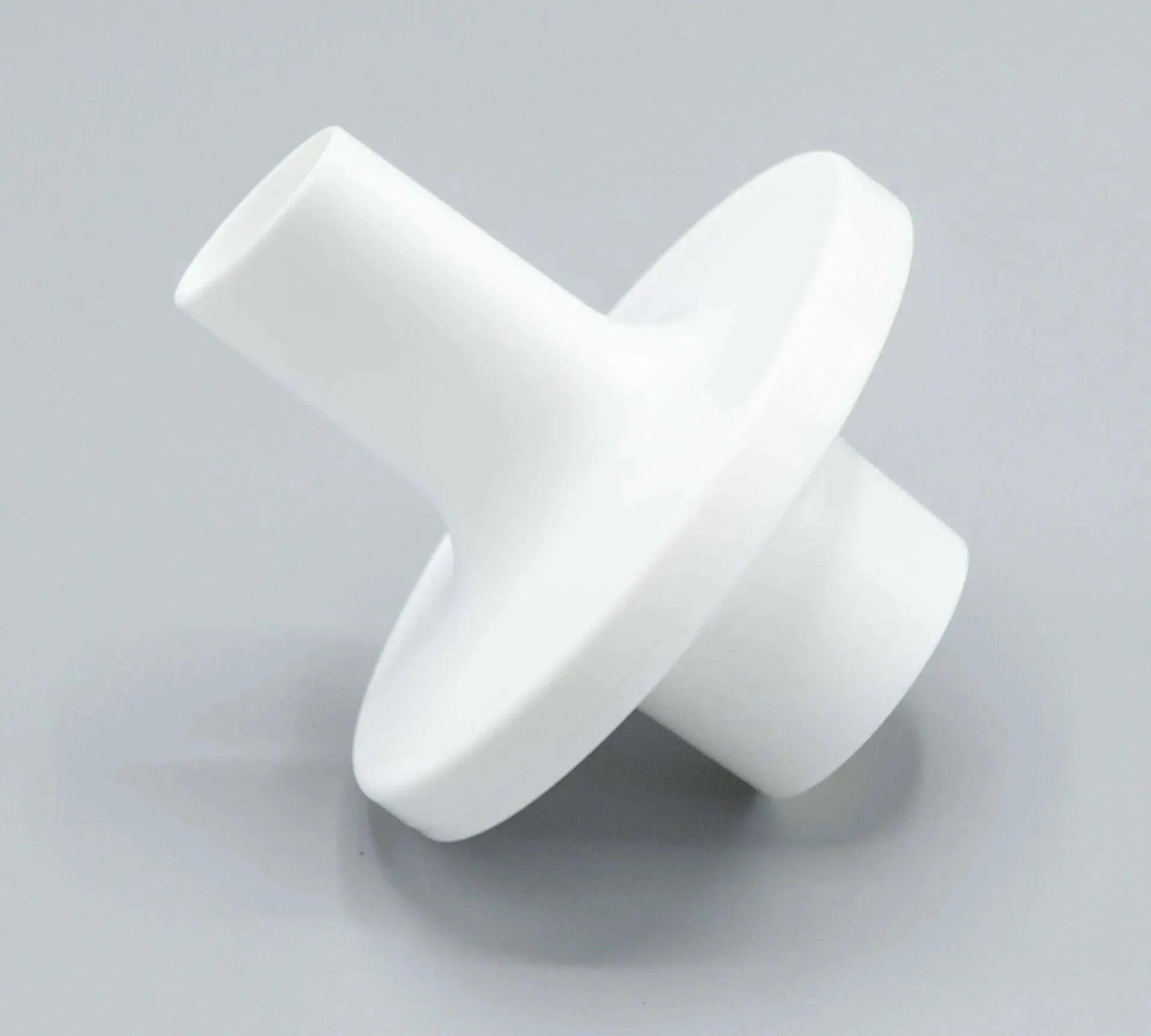 The bacterial/ viral filter mouthpiece shown is elliptical in shape, and white in color.