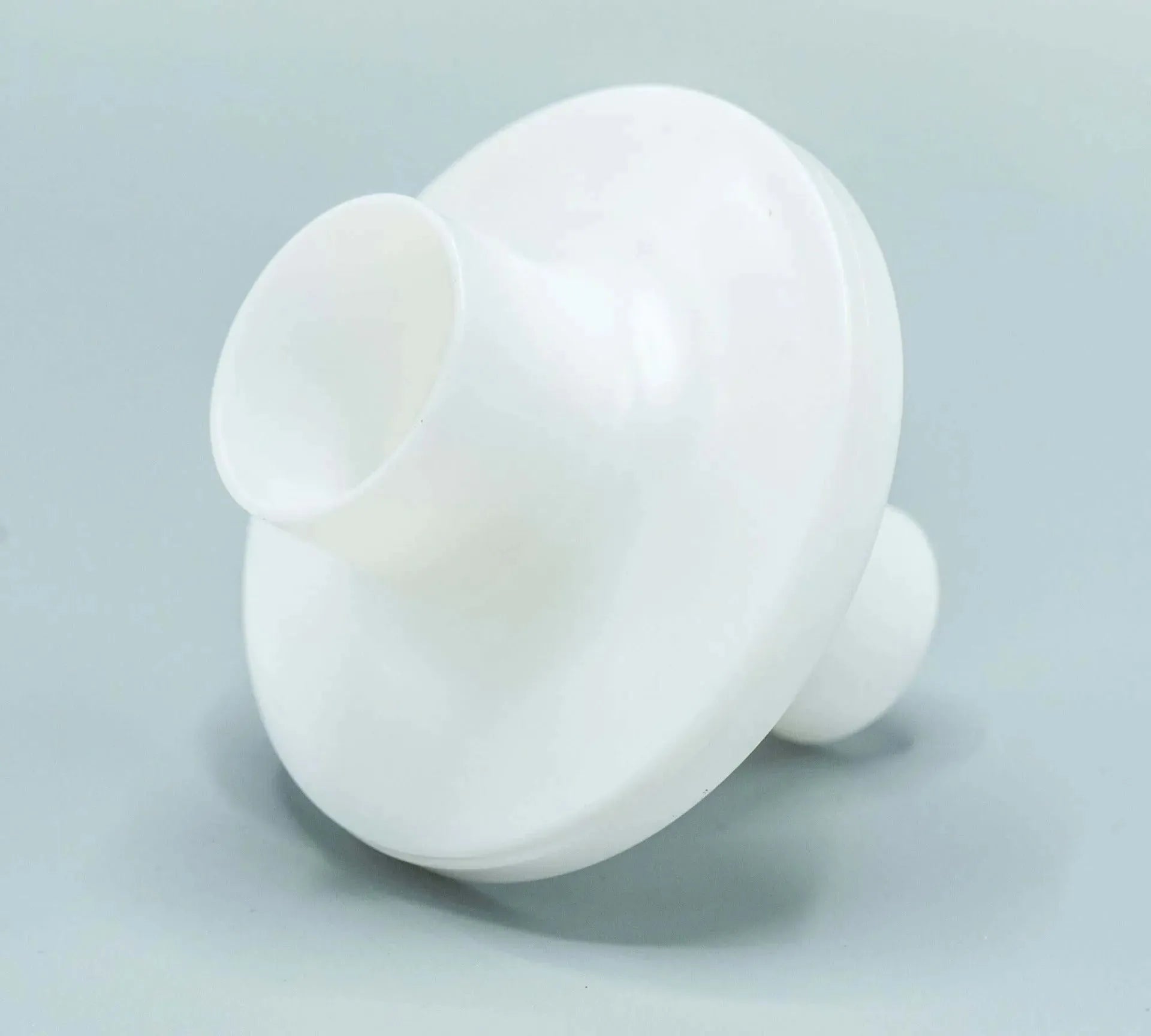 The bacterial/viral filter mouthpiece shown is round in shape, and white in color.